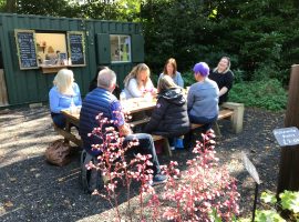 People relaxing Cleavley Community Forest Garden cafe Permission to use from Ian Bocock