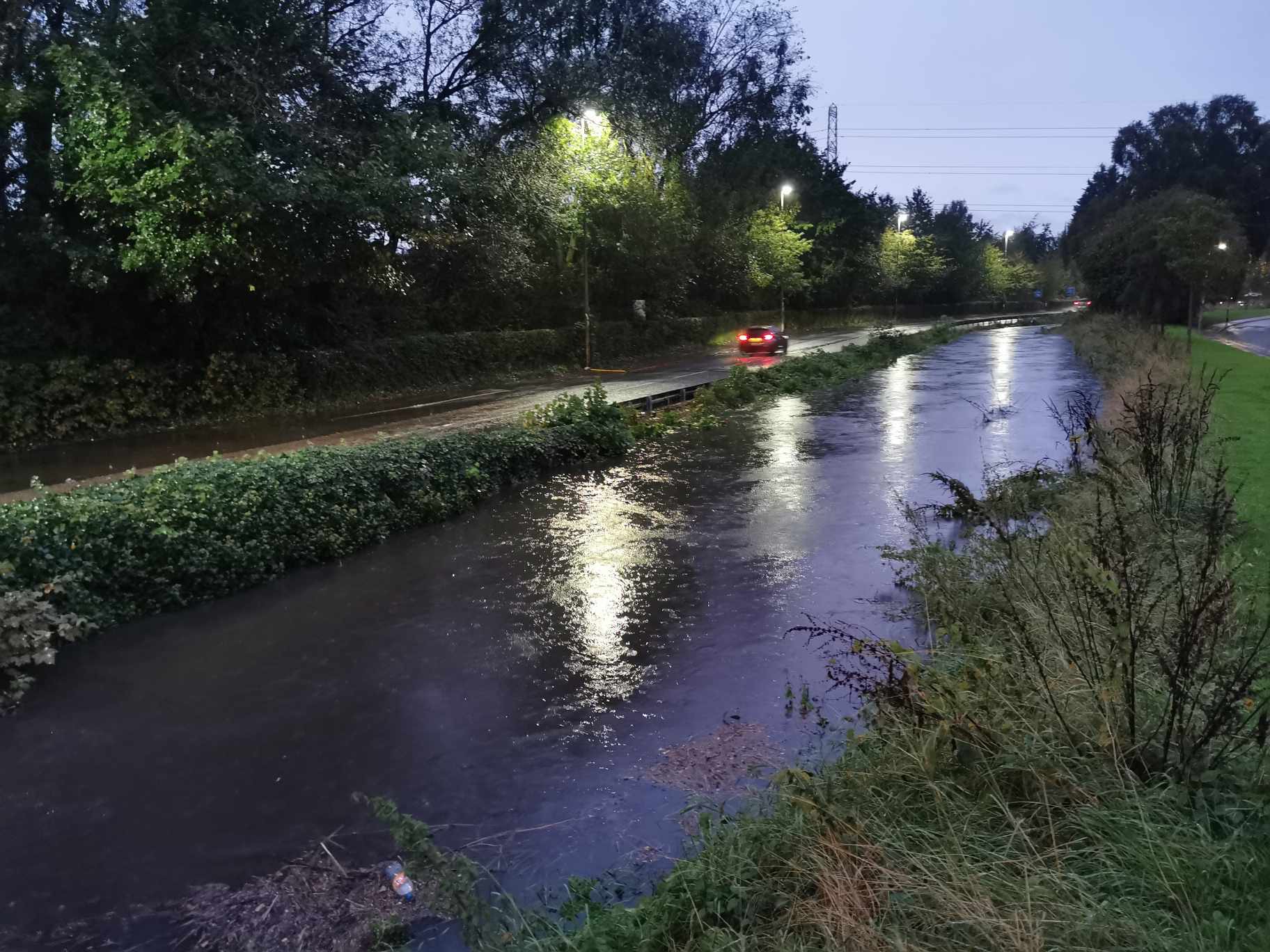 Salford brook levels soar past highest records as banks burst after torrential rain