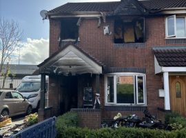 Woman taken to hospital after house fire in Monton