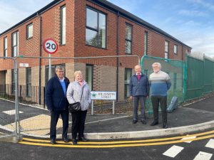 Joe Martin's siblings pose next to his newly unveiled sign 