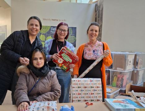 National Literacy Trust wrapping books for Boothstown children - via National Literacy Trust