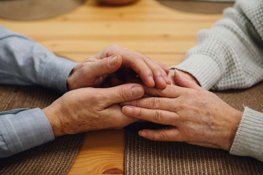 Salford Pensioners Elderly couple holding hands. Image Credit: T Leish