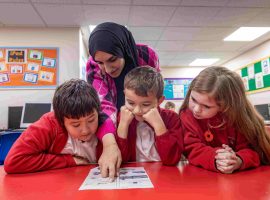 Tutor Trust helper supporting Year 5 pupils in Salford Credit: Tutor Trust