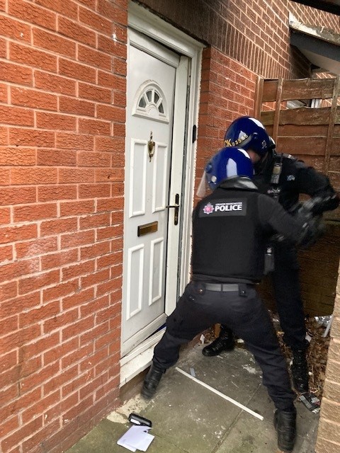 GMP officers battering door down - from GMP