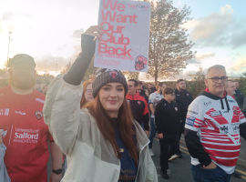 "We want our club back" - Salford Red Devils fan holds sign at the 1873 protest.