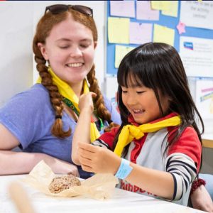 Guide leader helping child with activity